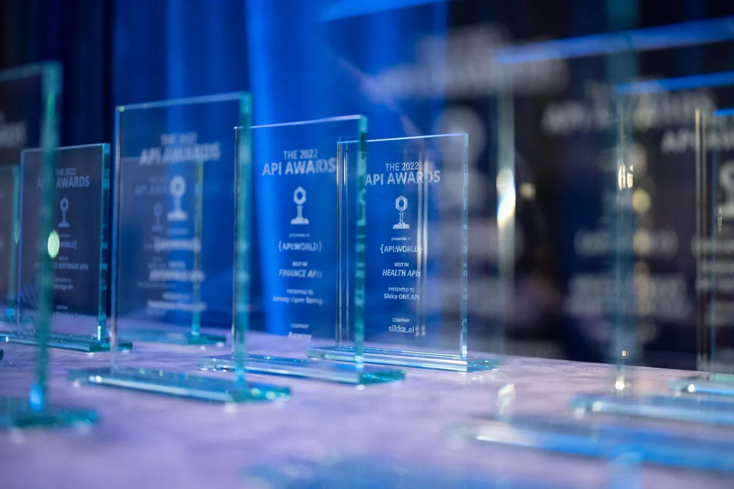 A collection of engraved glass API Awards